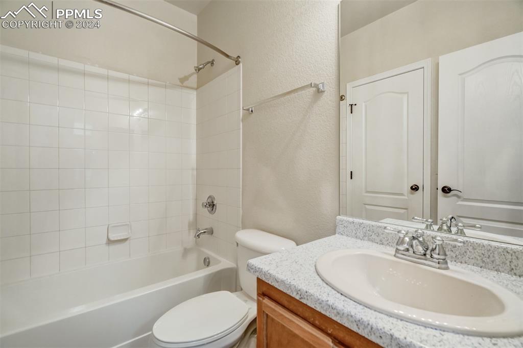 5353 Palomino Ranch Point, Unit 202 Colorado Springs, CO 80922 - Photo 30 of 34 a bathroom with a granite countertop sink toilet tub and shower