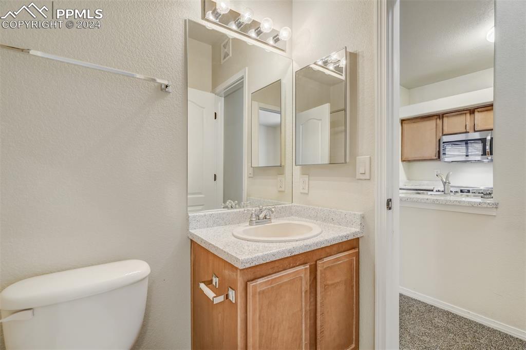 5353 Palomino Ranch Point, Unit 202 Colorado Springs, CO 80922 - Photo 31 of 34 a bathroom with a sink a toilet and shower