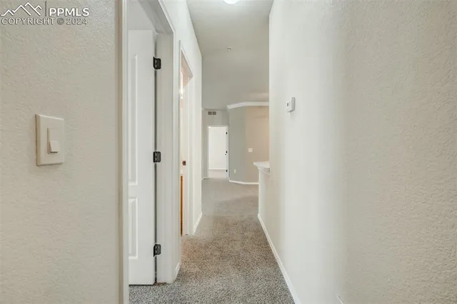 a view of a bathroom from a hallway
