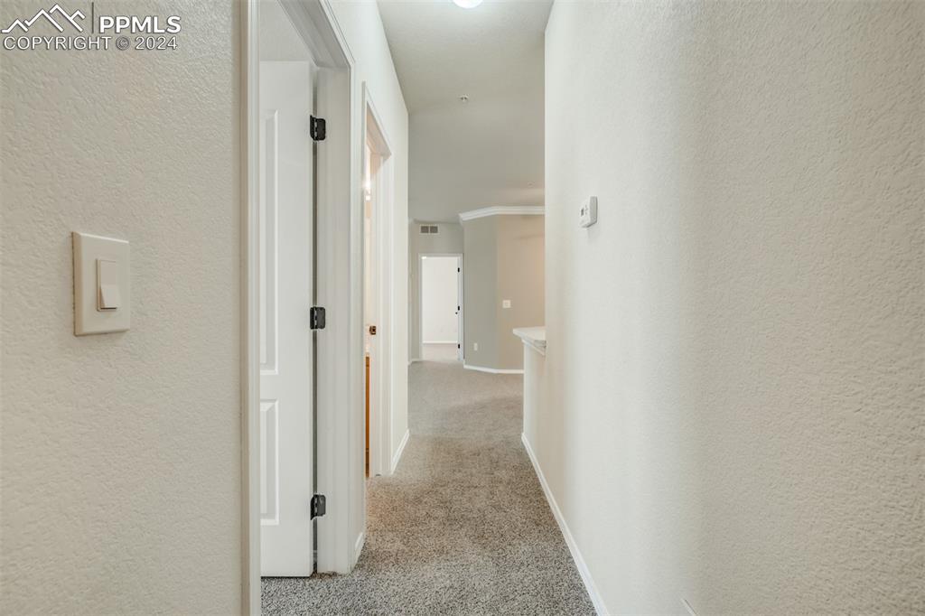 5353 Palomino Ranch Point, Unit 202 Colorado Springs, CO 80922 - Photo 5 of 34 a view of a bathroom from a hallway