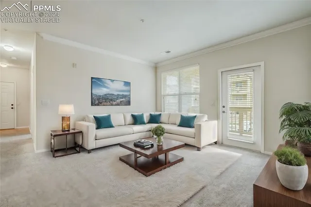 a living room with furniture potted plant and windows