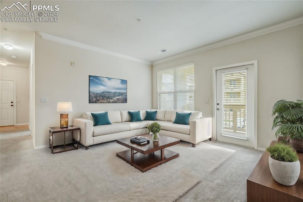 5353 Palomino Ranch Point, Unit 202 Colorado Springs, CO 80922 - Photo 8 of 34 a living room with furniture potted plant and windows
