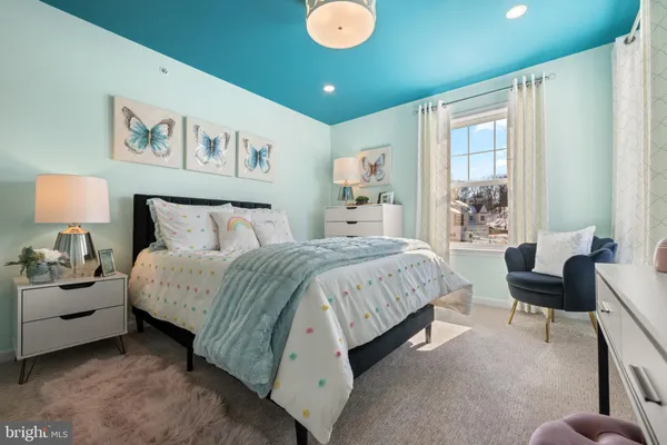 a spacious bedroom with a bed and a couch