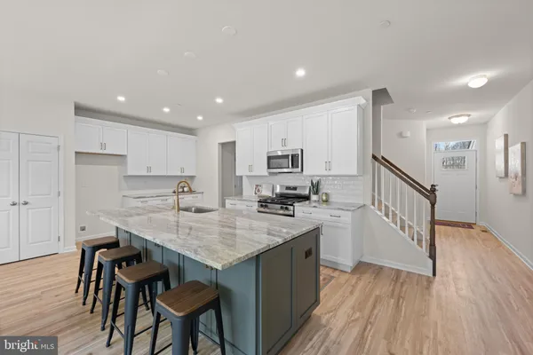 a kitchen with a sink stove and wooden cabinets
