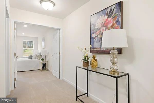 a bedroom with bed and white cabinets