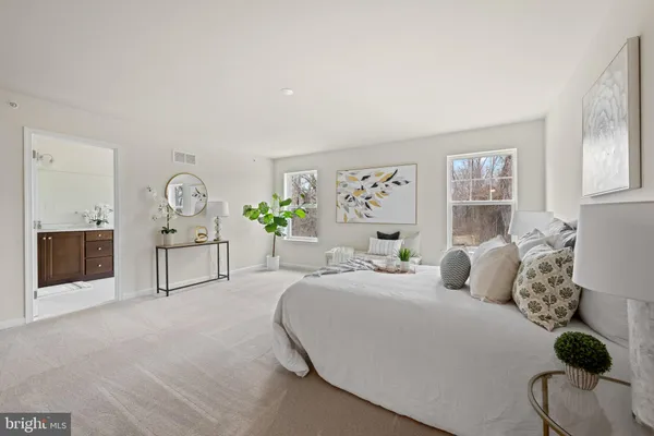 a spacious bedroom with a bed and a couch