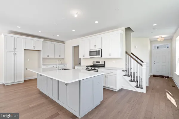 a kitchen that has a table and chairs in it