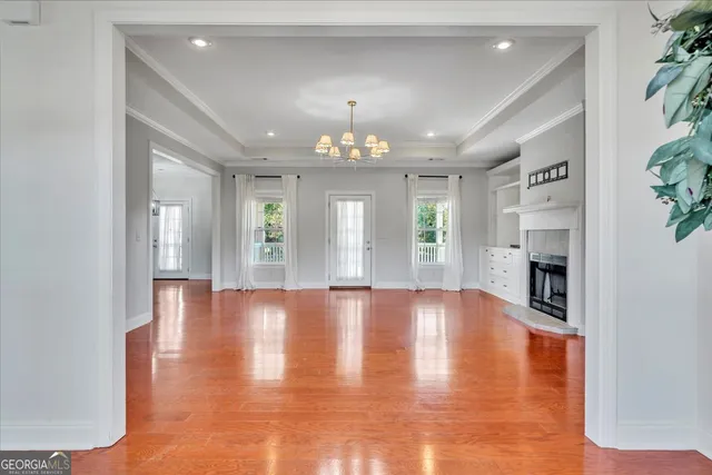 a view of an empty room with window and fireplace