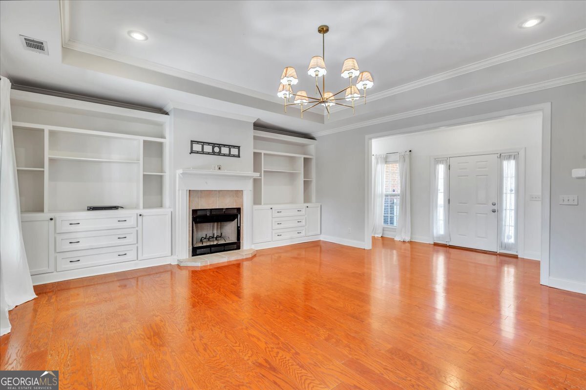 100 Fox Den Court Dublin, GA 31021 - Photo 3 of 26 a view of an empty room with a fireplace and a chandelier