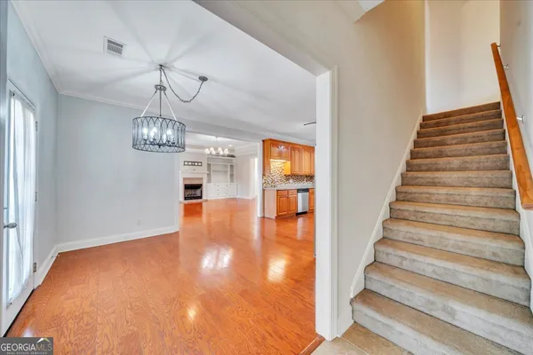a view of entryway and hall with wooden floor