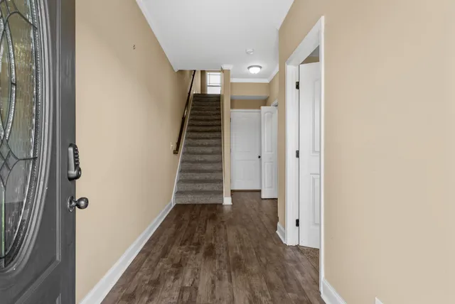 a view of a hallway with wooden floor and entryway