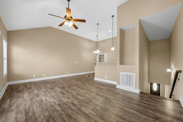 a view of an empty room and wooden floor