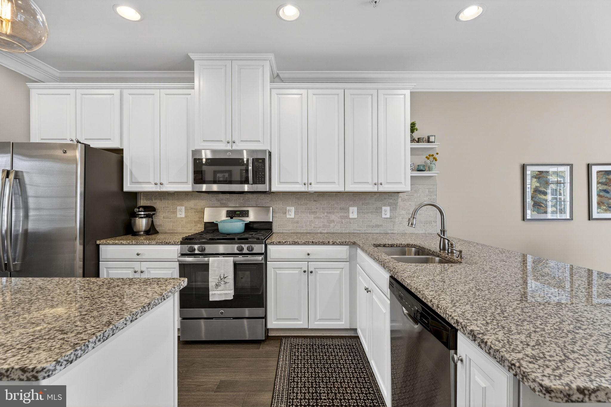 459 Haupt Square Southeast Leesburg, VA 20175 - Photo 14 of 80 a kitchen with stainless steel appliances granite countertop a stove sink and cabinets