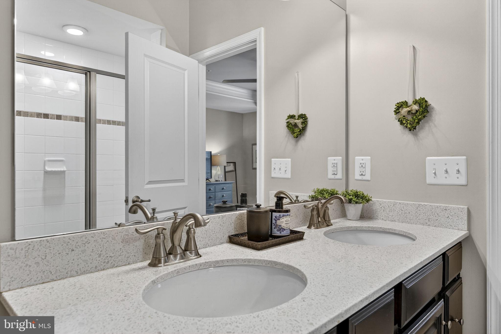 459 Haupt Square Southeast Leesburg, VA 20175 - Photo 38 of 80 a bathroom with a granite countertop sink and a mirror