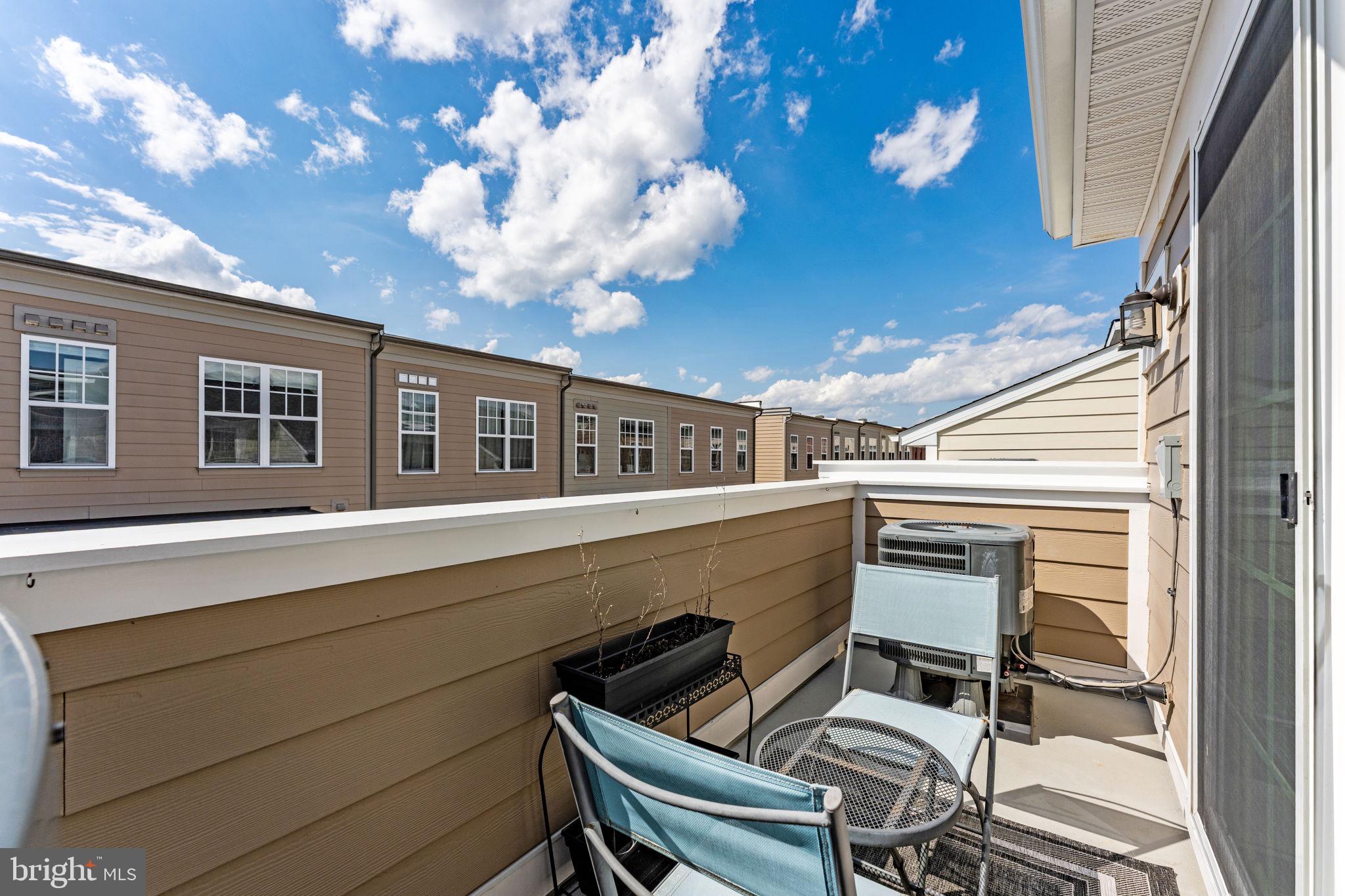 459 Haupt Square Southeast Leesburg, VA 20175 - Photo 58 of 80 a view of a chair and tables in the balcony