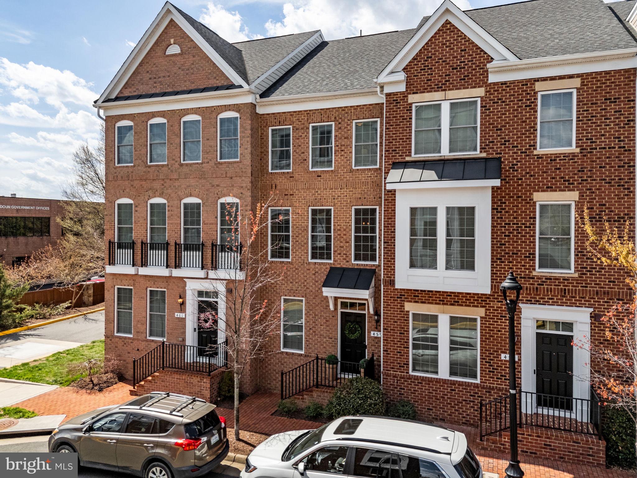 459 Haupt Square Southeast Leesburg, VA 20175 - Photo 76 of 80 a front view of a residential apartment building with a yard