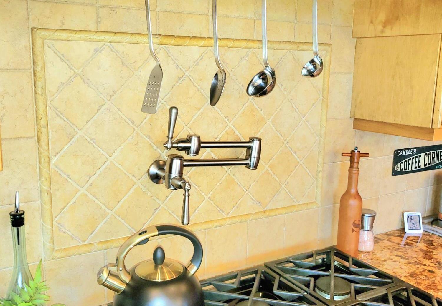 1440 Dog Bar Road Colfax, CA 95713 - Photo 19 of 93 Kitchen view of pot filler, backsplash, gas cooktop, and light granite counters