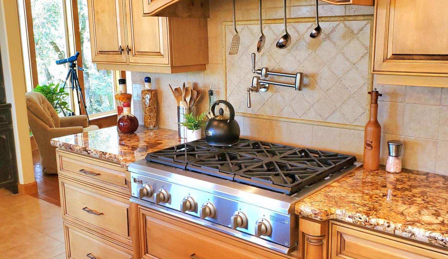 1440 Dog Bar Road Colfax, CA 95713 - Photo 20 of 93 Kitchen with stainless steel gas cooktop, light granite countertops, tasteful backsplash, and light tile patterned flooring