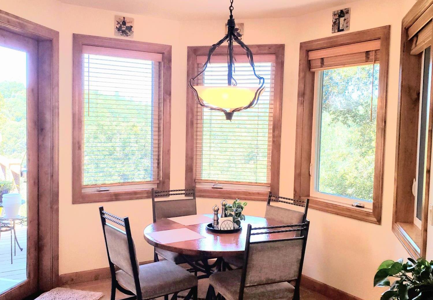 1440 Dog Bar Road Colfax, CA 95713 - Photo 21 of 93 In-kitchen light and bright dining area featuring tile patterned flooring with mountain views. The glass doorway opens to the deck. Windows and door fill this kitchen with sunlight. A great place to start your day!