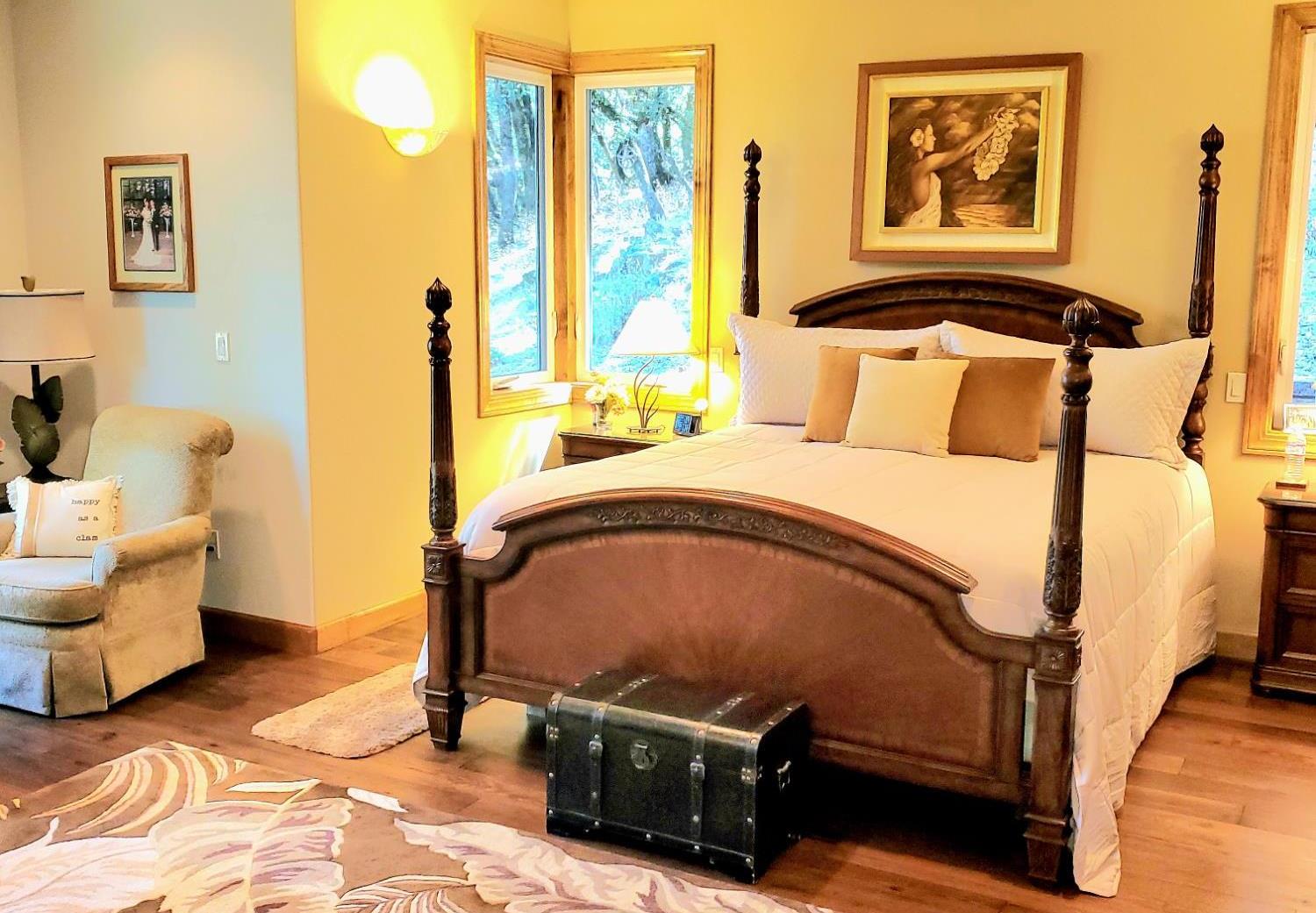 1440 Dog Bar Road Colfax, CA 95713 - Photo 26 of 93 Mater Bedroom featuring light engineered hardwood flooring (different style than the rest of the home flooring), recessed lighting, and ceiling fan. Lots of windows and glass door fill the Master Bedroom with sunlight (or moonlight).