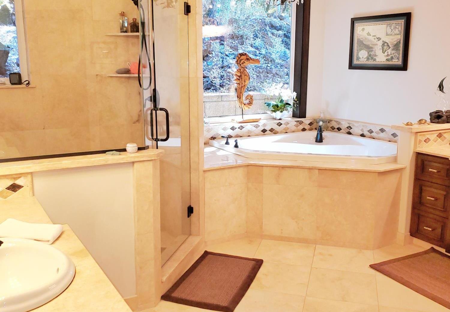 1440 Dog Bar Road Colfax, CA 95713 - Photo 29 of 93 Master Bathroom with her & his vanities, a glass and tile shower stall, a jetted tub, tile patterned heated flooring, and chandelier. Lots of windows but very private.