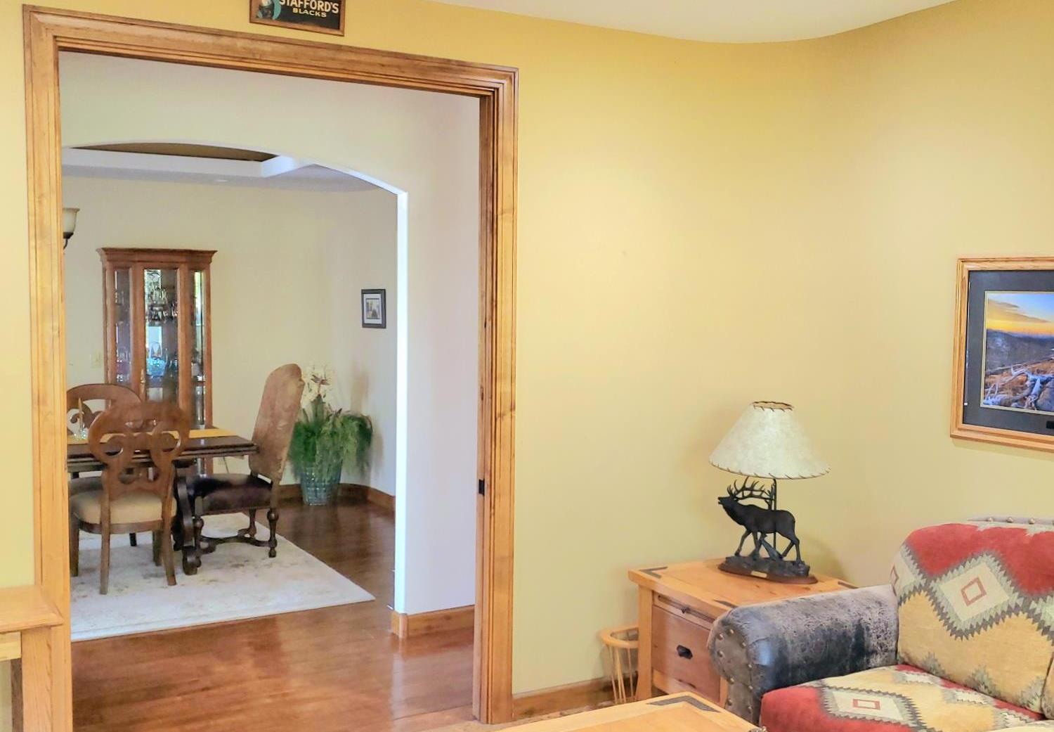 1440 Dog Bar Road Colfax, CA 95713 - Photo 62 of 93 Bedroom 3 pocket doors open to living area featuring arched walkways, ceiling fan, and cork flooring.