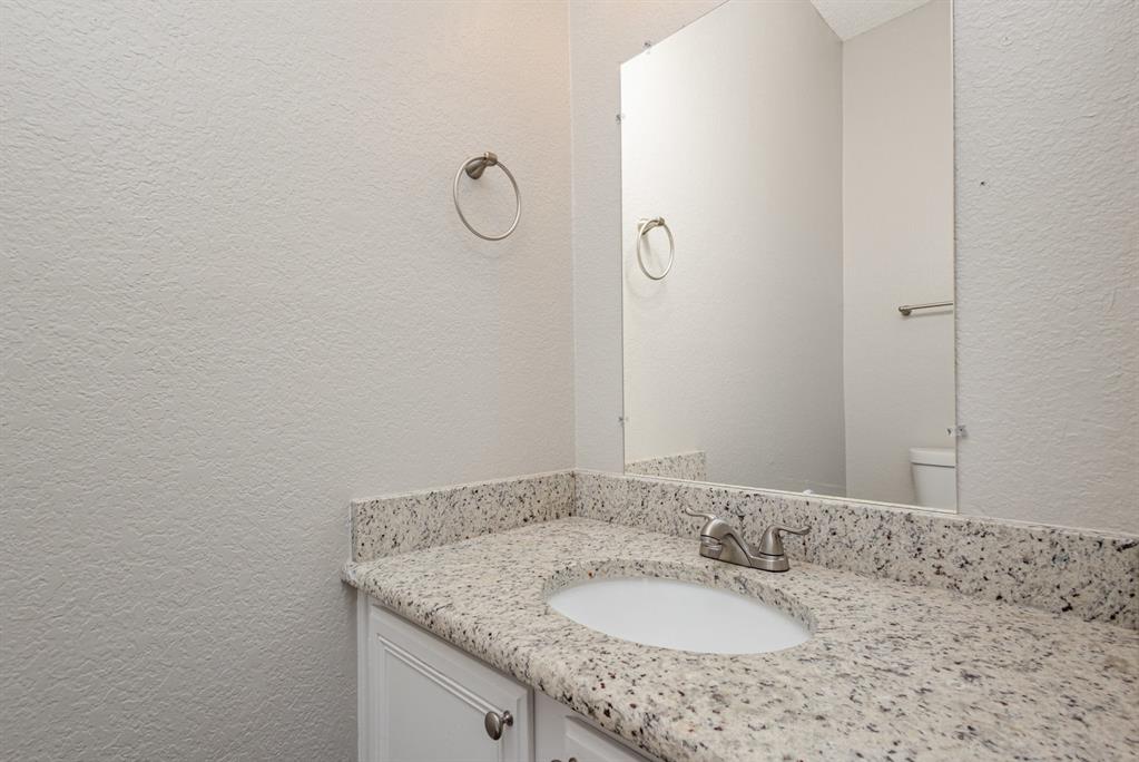 7100 Layla Road Arlington, TX 76016 - Photo 13 of 19 Bathroom featuring a textured wall and vanity