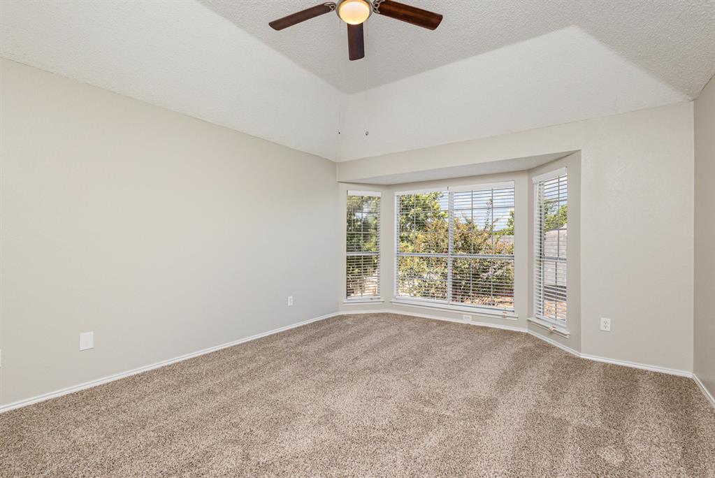 7100 Layla Road Arlington, TX 76016 - Photo 15 of 19 Unfurnished room with a textured ceiling, carpet, and ceiling fan