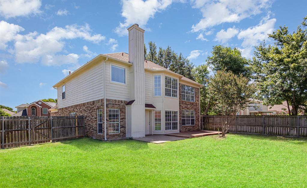 7100 Layla Road Arlington, TX 76016 - Photo 2 of 19 Back of property with brick siding, a fenced backyard, a patio, and a chimney