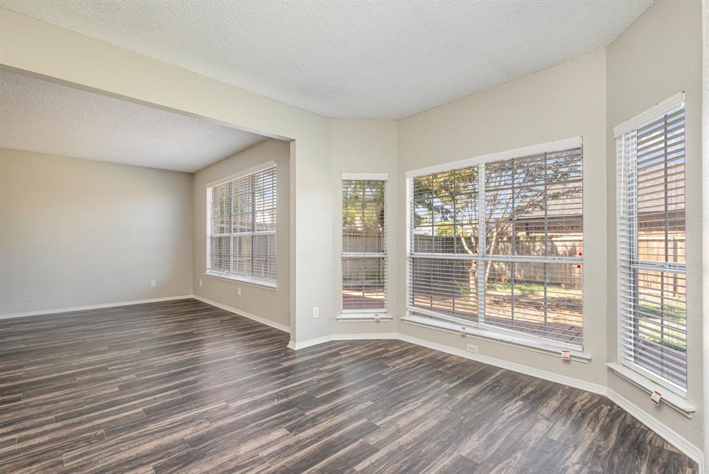 7100 Layla Road Arlington, TX 76016 - Photo 5 of 19 Spare room with a textured ceiling and dark wood finished floors