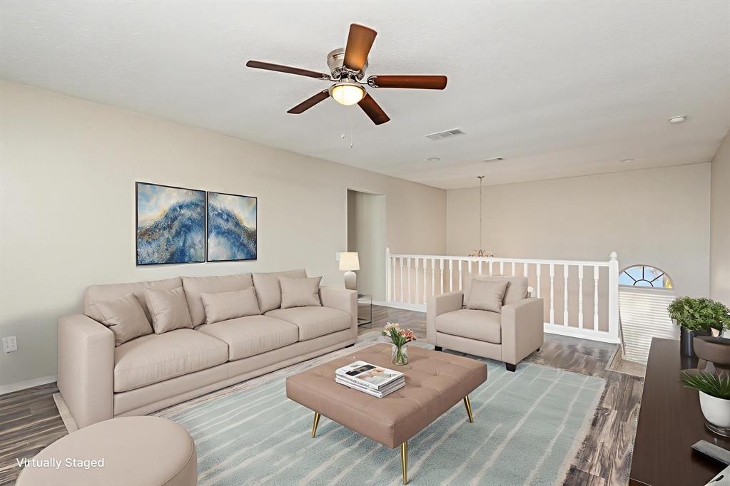 7100 Layla Road Arlington, TX 76016 - Photo 9 of 19 Virtually staged-Living room with wood finished floors, ceiling fan, and a chandelier