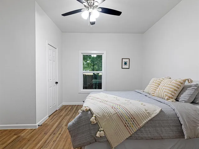 a bedroom with a bed and wooden floor