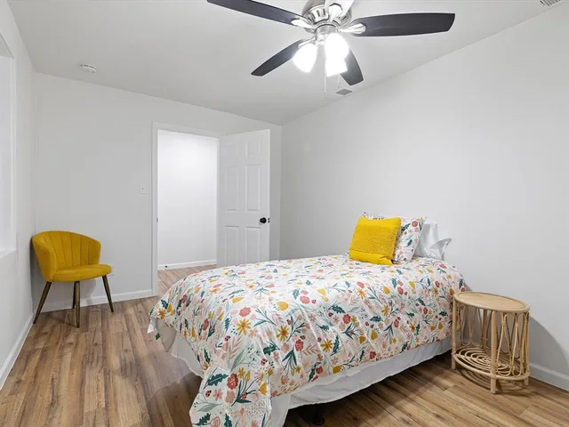 a white toilet sitting next to a white cabinet