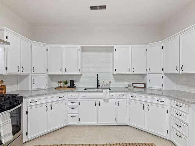 a kitchen with a sink and cabinets