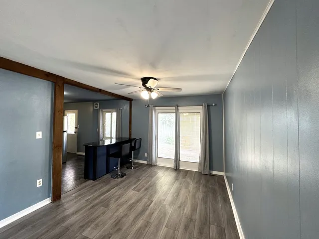 wooden floor in an empty room with a window