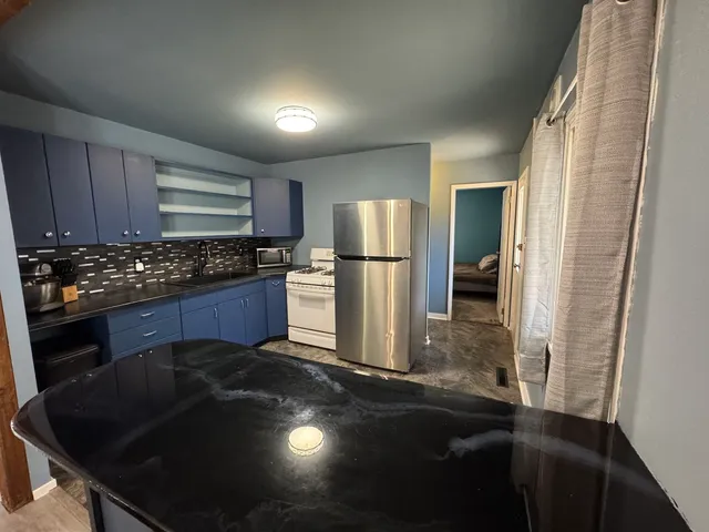 a kitchen with a sink stove and refrigerator