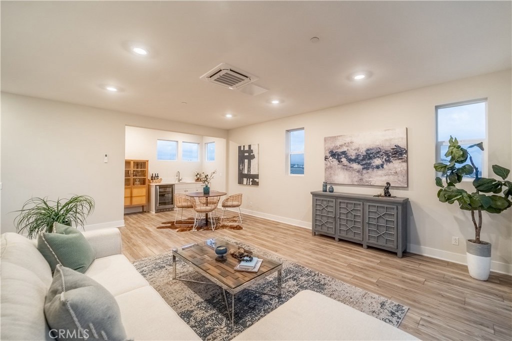 599 Serrano Summit Drive Lake Forest, CA 92630 - Photo 15 of 19 a living room with furniture plant and wooden floor