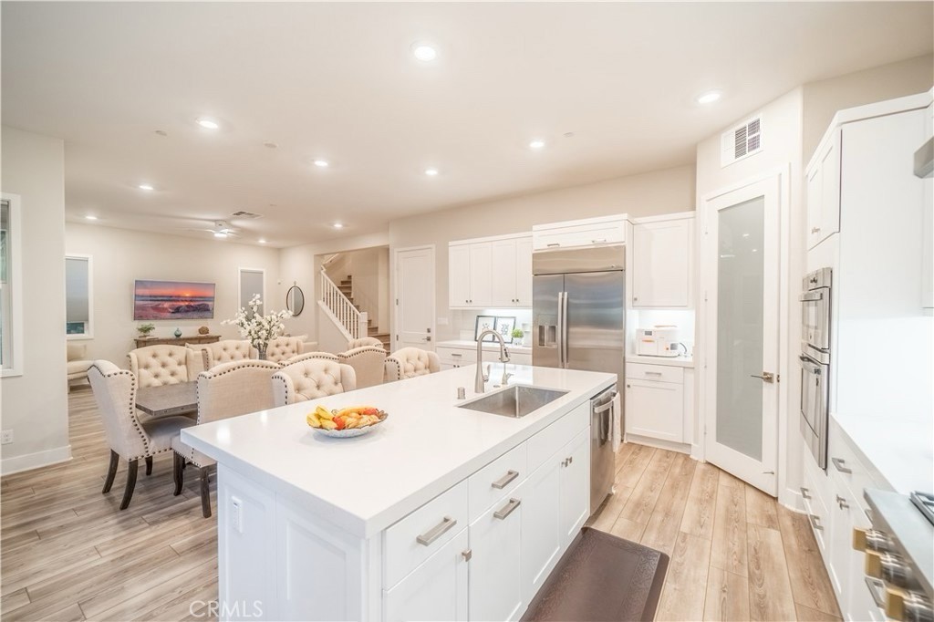 599 Serrano Summit Drive Lake Forest, CA 92630 - Photo 4 of 19 a kitchen with stainless steel appliances kitchen island granite countertop a sink and refrigerator