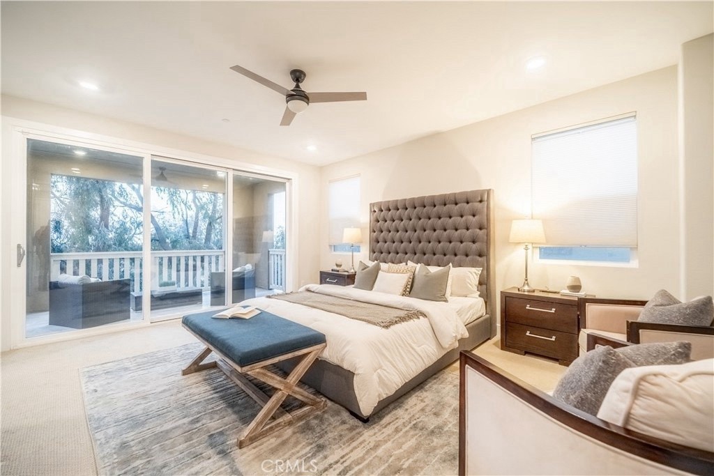 599 Serrano Summit Drive Lake Forest, CA 92630 - Photo 9 of 19 a bedroom with a bed a large window and wooden floor