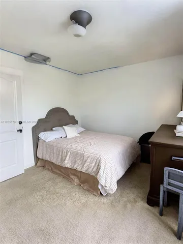 a bedroom with a bed and a chair