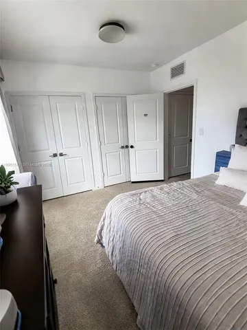 a bedroom with a bed and cabinets