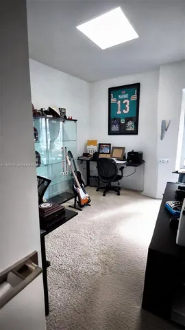 a living room with furniture gym equipment and a flat screen tv