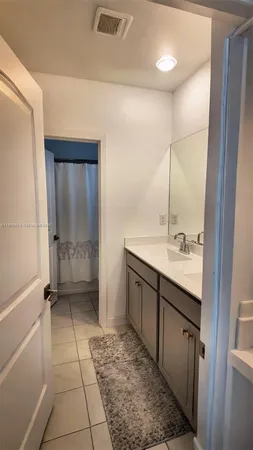 a bathroom with a sink a mirror and a shower