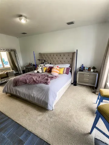 a bedroom with a bed and a desk