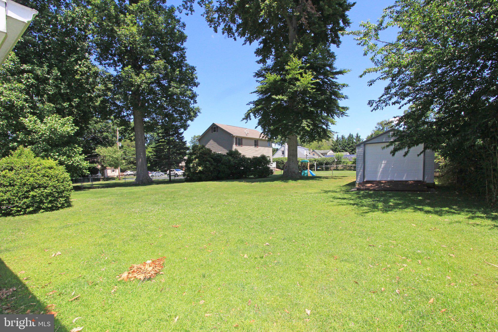929 Cherry Tree Road Aston, PA 19014 - Photo 26 of 26 Spacious green yard under clear skies.