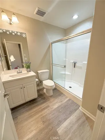 a bathroom with a double vanity sink mirror and toilet