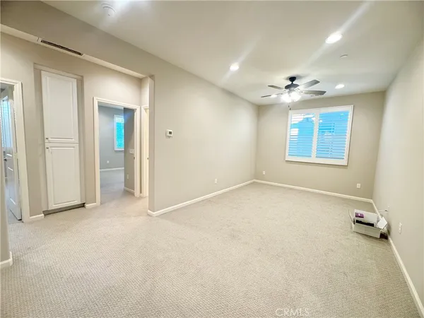 an empty room with windows and closet