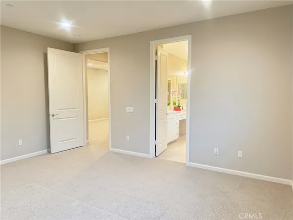 an empty room with closet and a bathroom