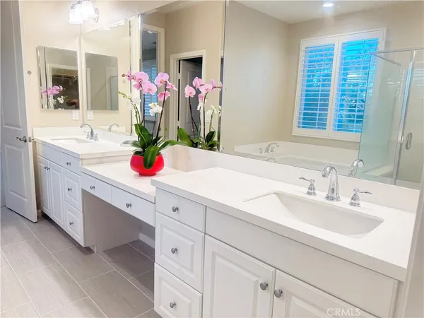a bathroom with a sink vanity tub and a mirror