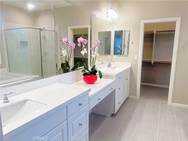 a bathroom with a sink vanity tub and shower